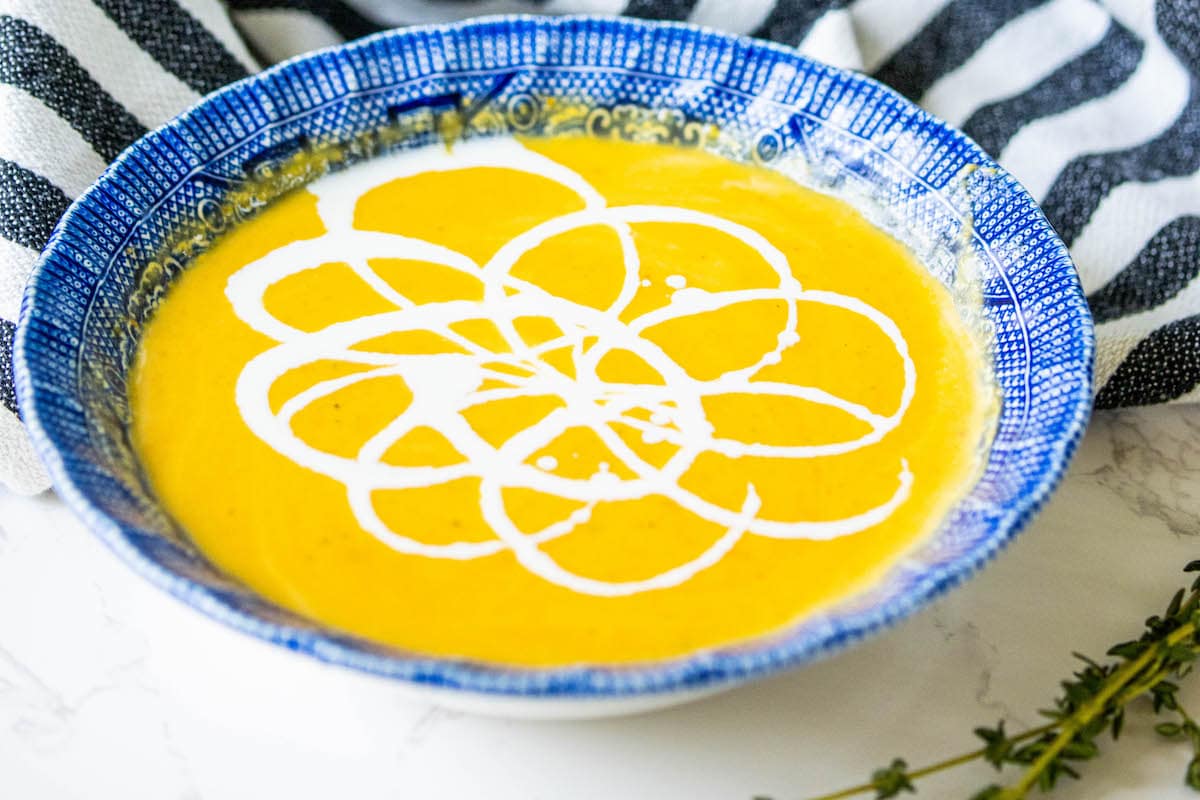 yellow soup with white cream decoration