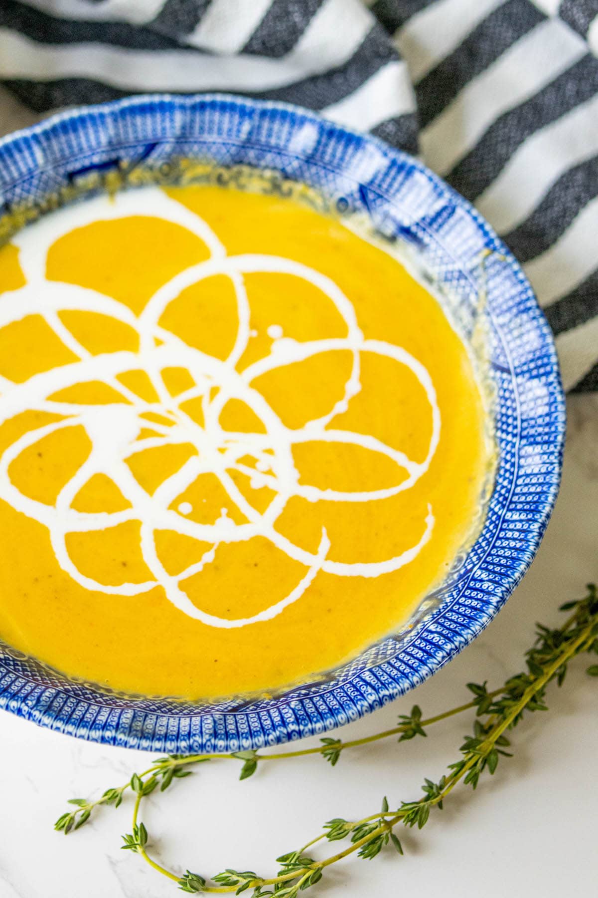 yellow soup with white cream decoration