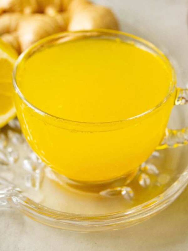cup of bright orange tea in a glass mug