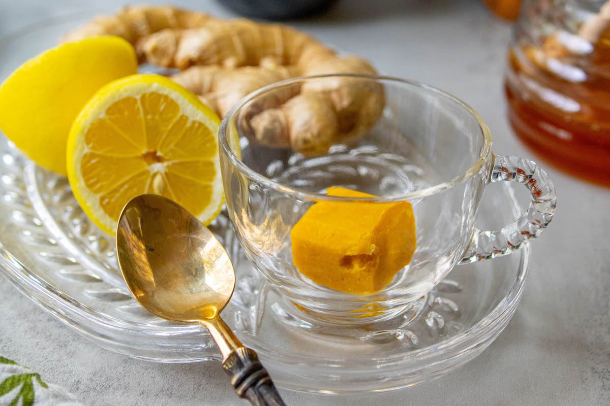 cup of bright orange tea in a glass mug