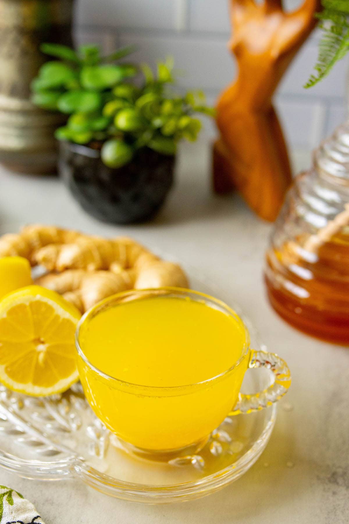 cup of bright orange tea in a glass mug