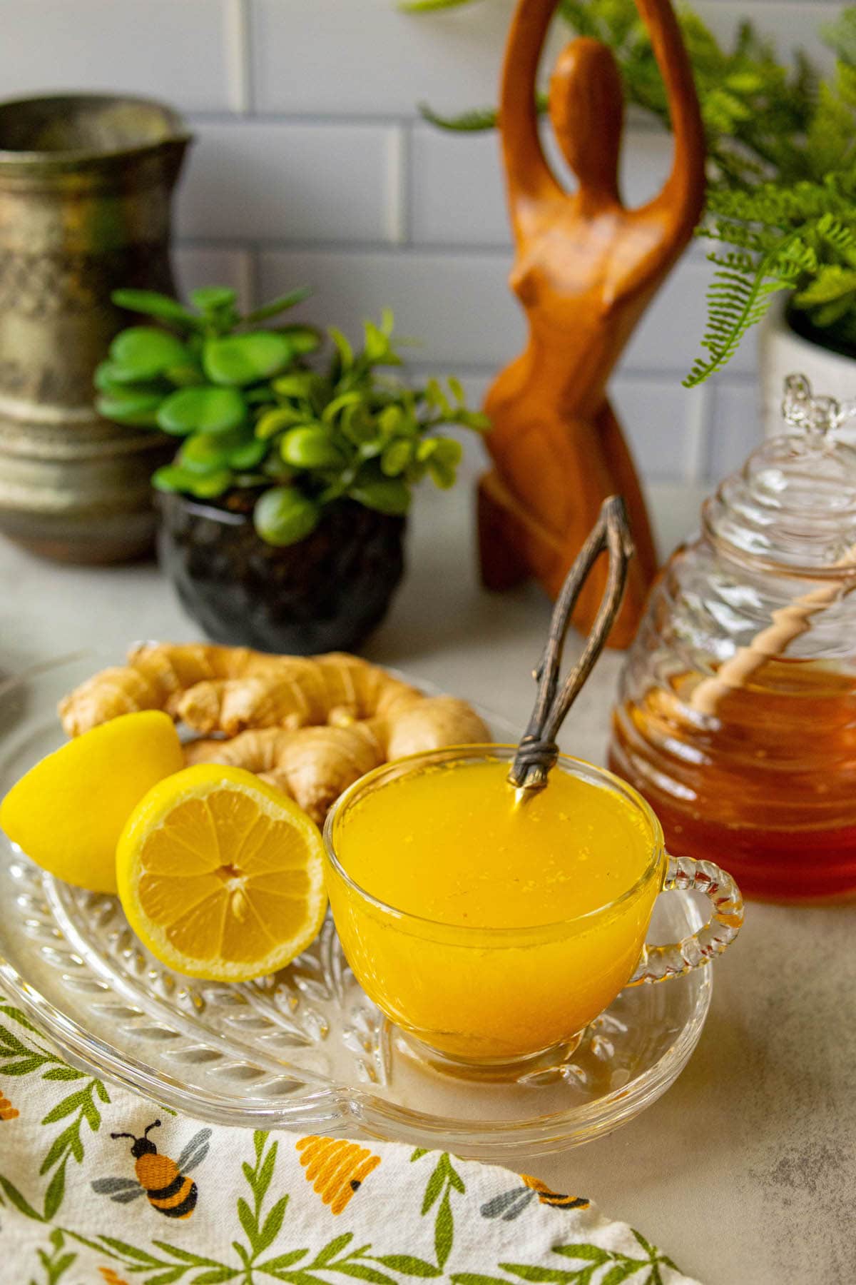 cup of bright orange tea in a glass mug