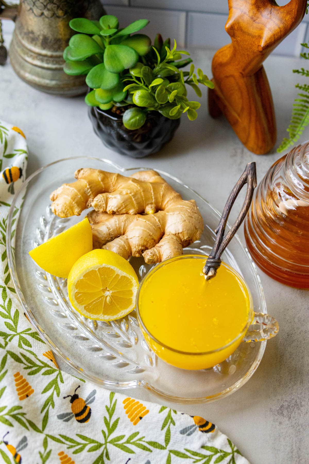 cup of bright orange tea in a glass mug