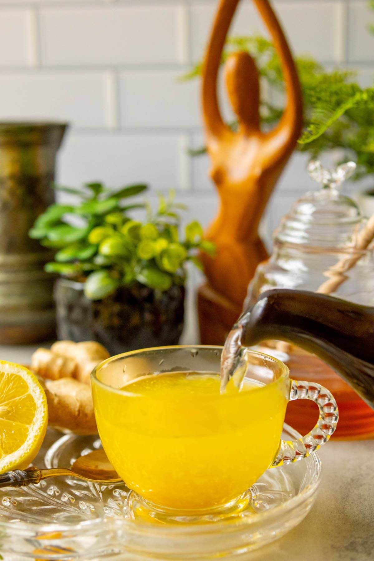 cup of bright orange tea in a glass mug