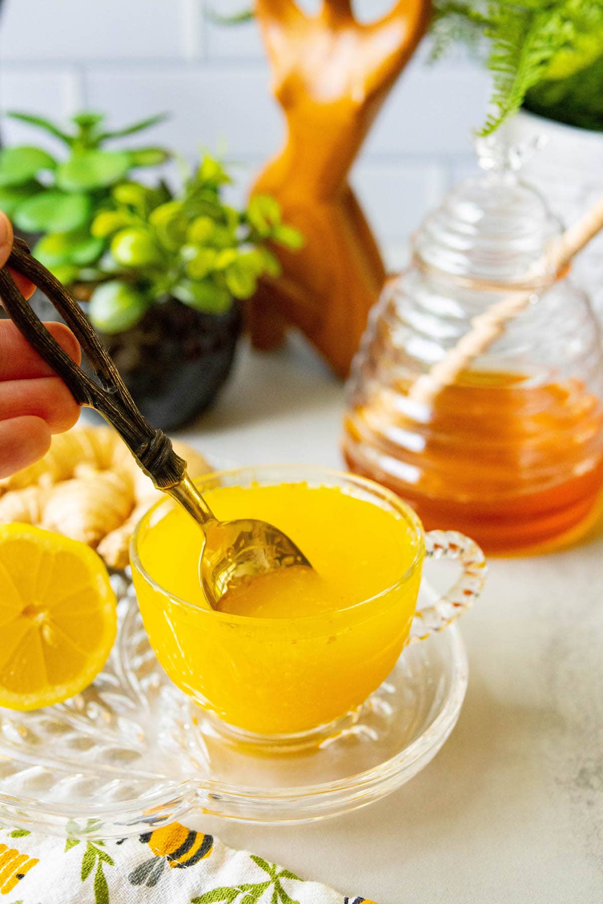 cup of bright orange tea in a glass mug