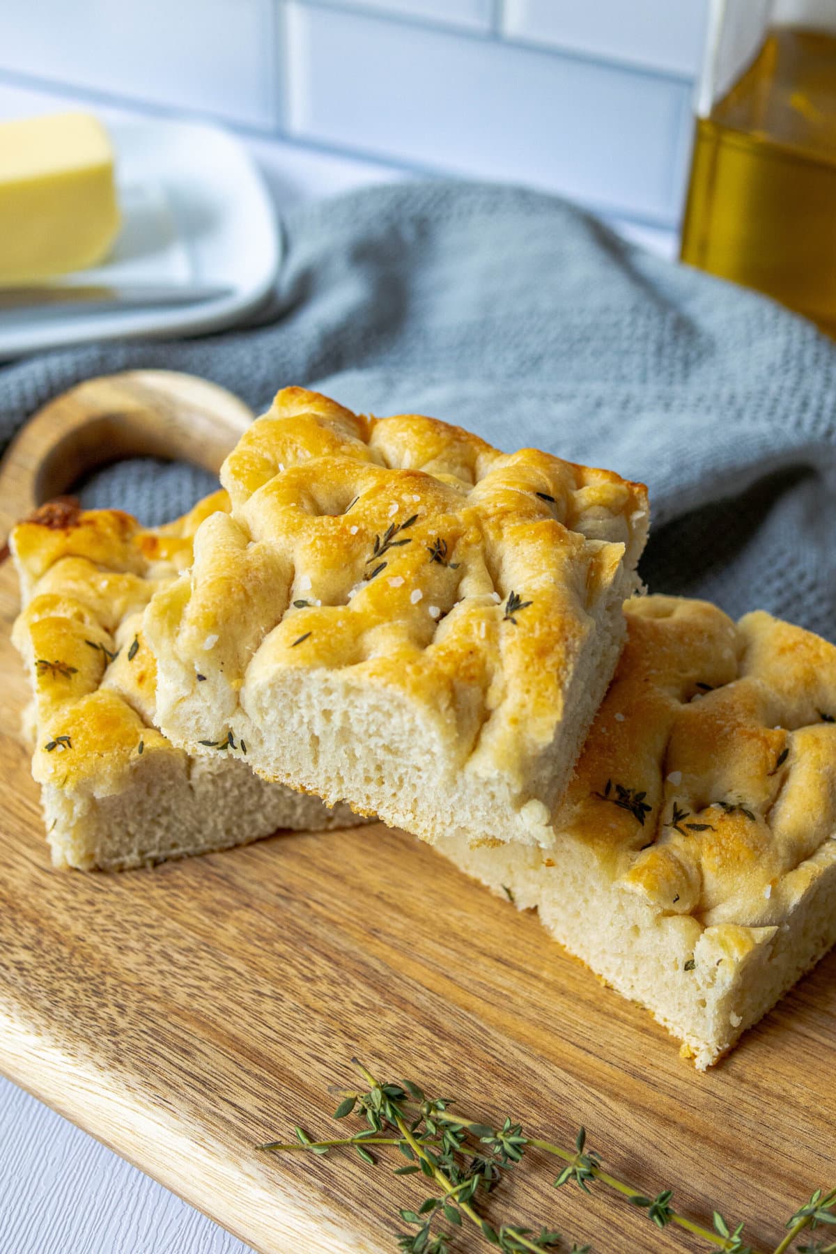 slices of herb focaccia with salt stacked on top of each other 