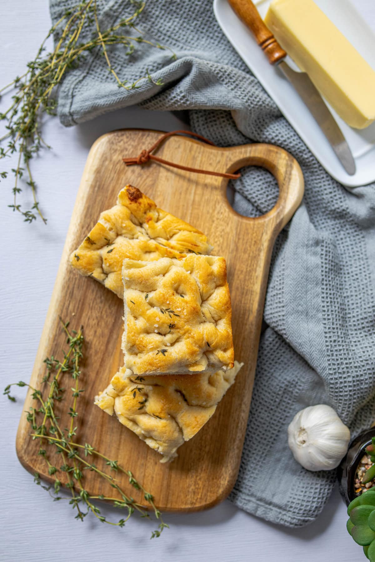 slices of herb focaccia with salt stacked on top of each other 