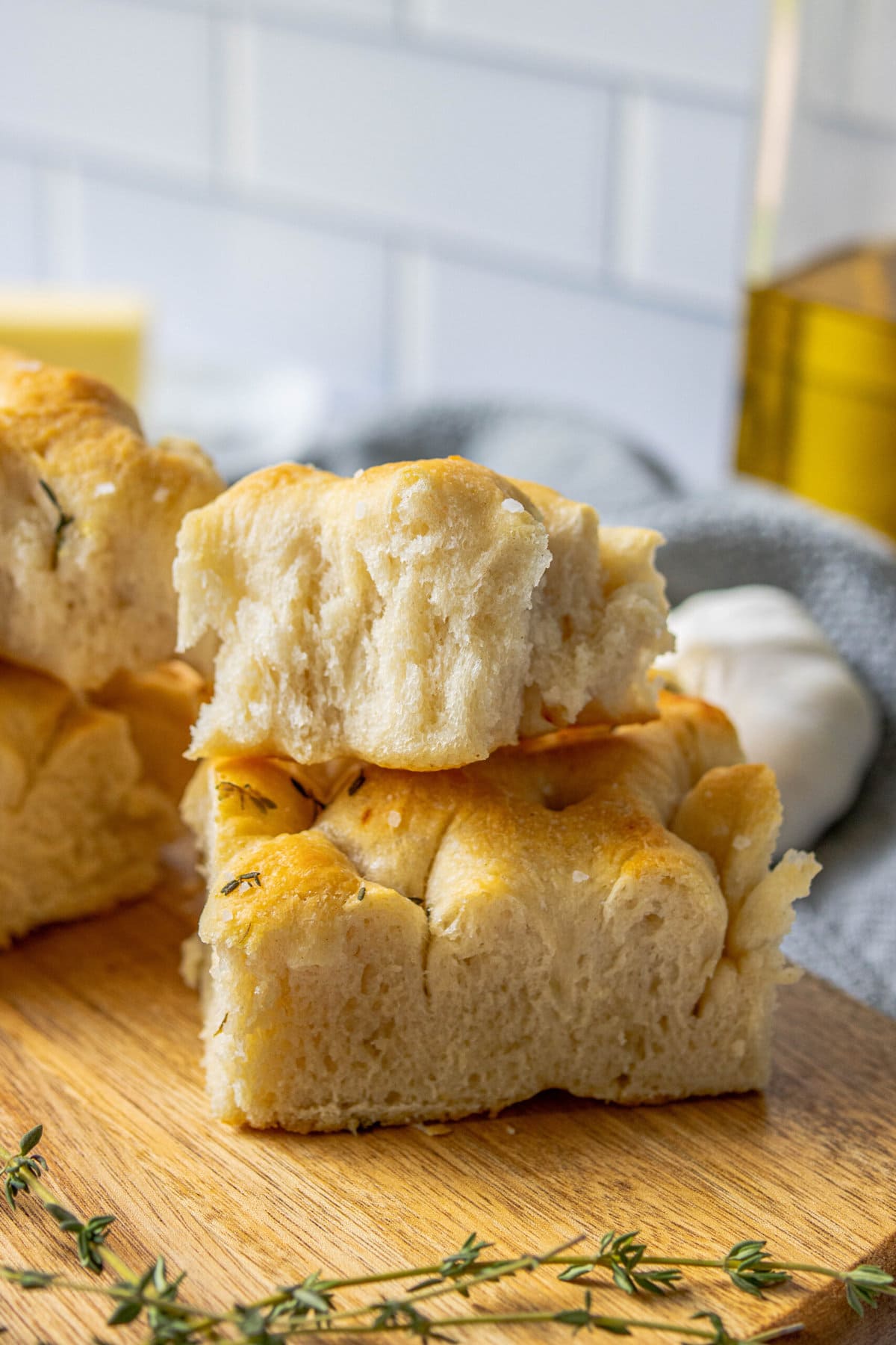 slices of herb focaccia with salt stacked on top of each other 