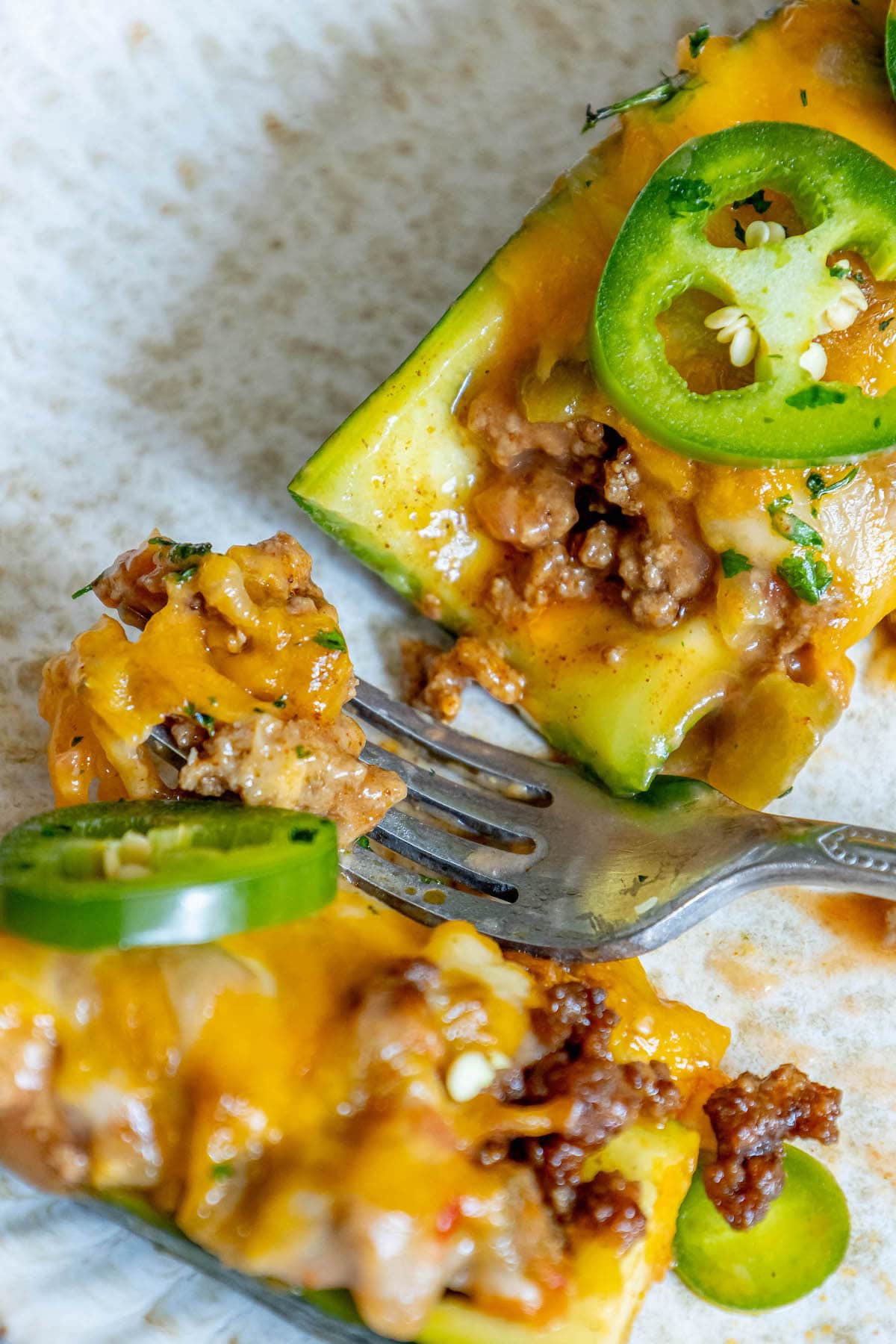 baked zucchini with cheesy taco filling in it