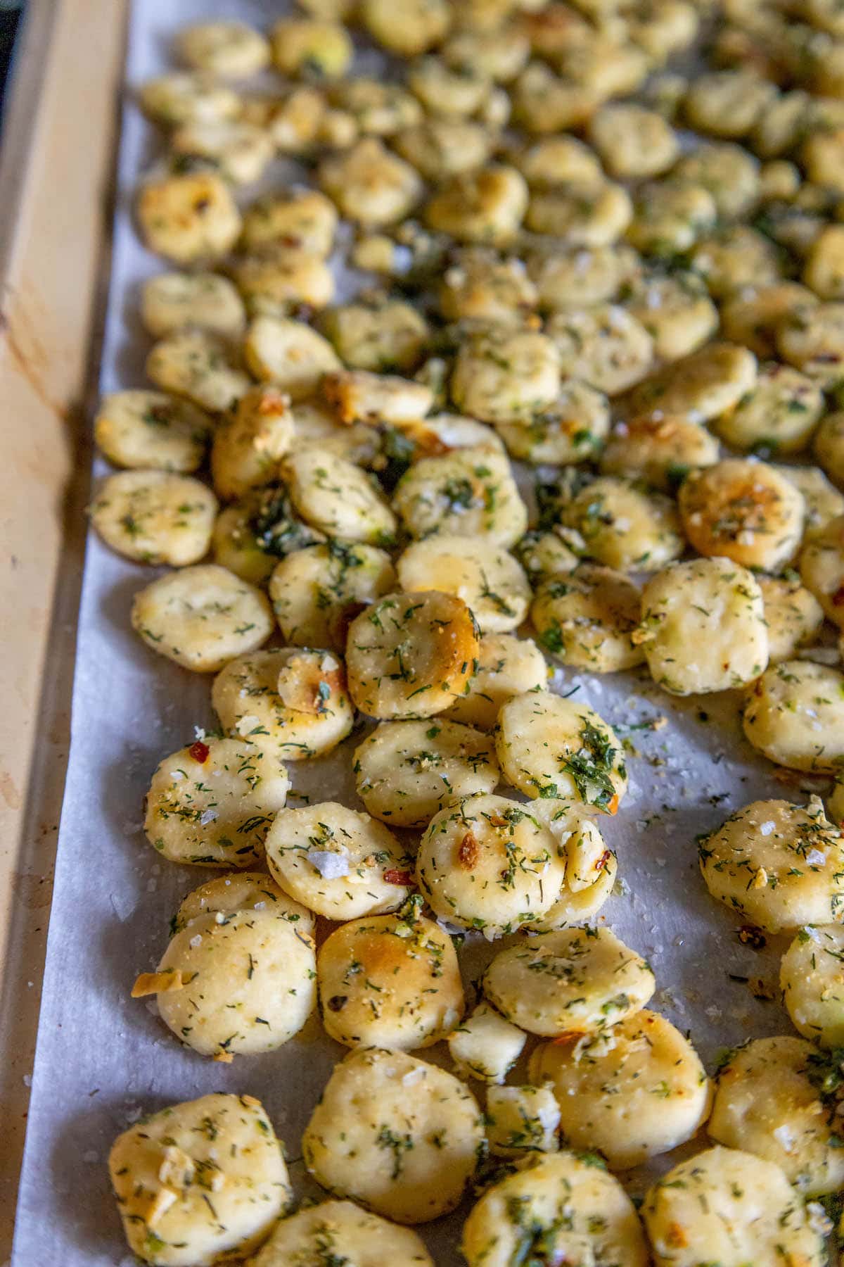 baked crispy oyster crackers on a baking sheet on a table