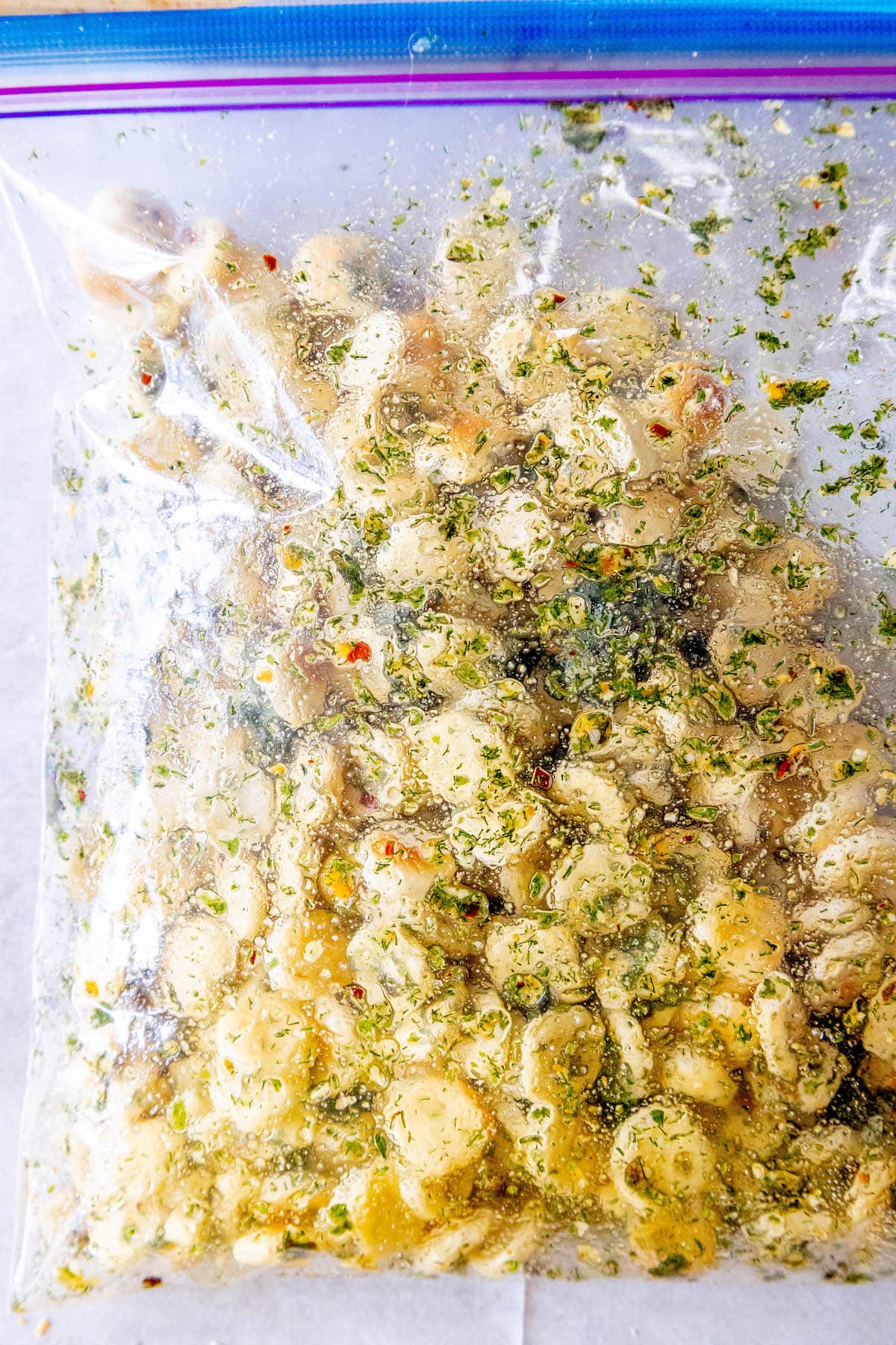 oyster crackers in a bag with herbs and spices on a table