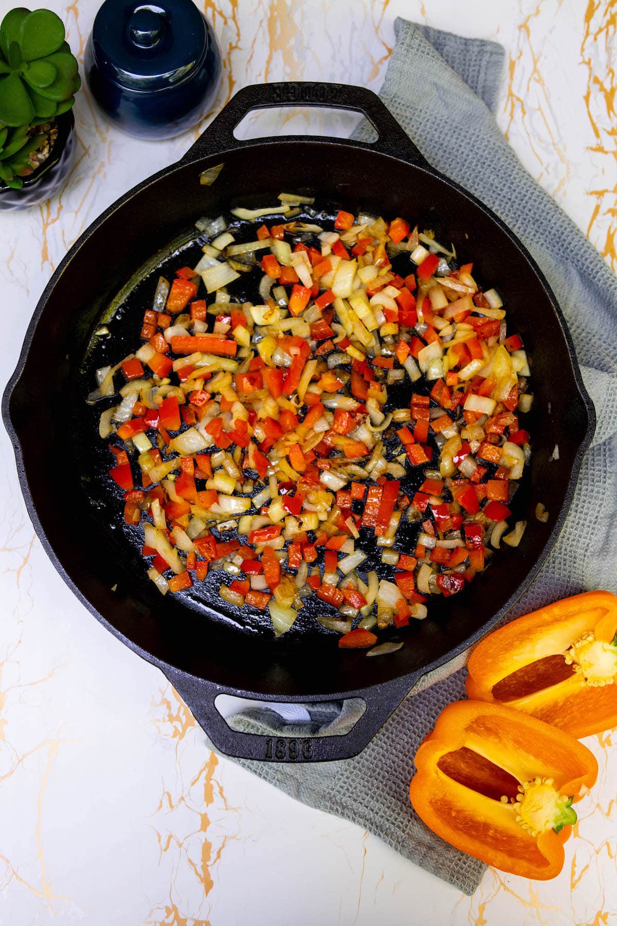 vegetables being browned in a pan