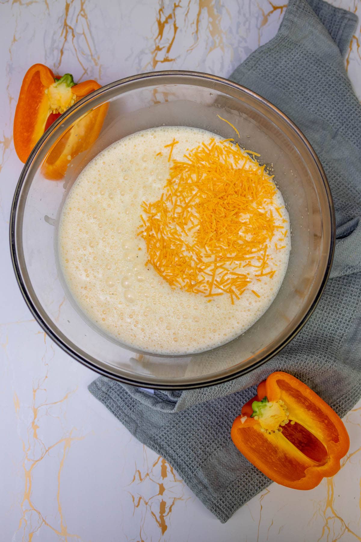 eggs, milk, shredded cheese in a bowl