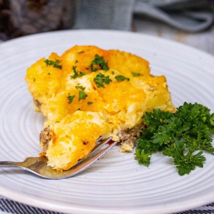 cheesy baked tater tot casserole on a white plate