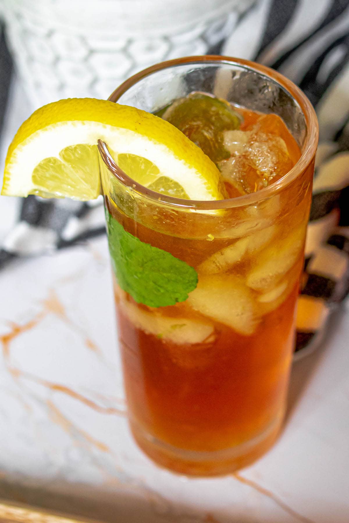 lemonade iced tea arnold palmer in a pitcher with sliced citrus and mint