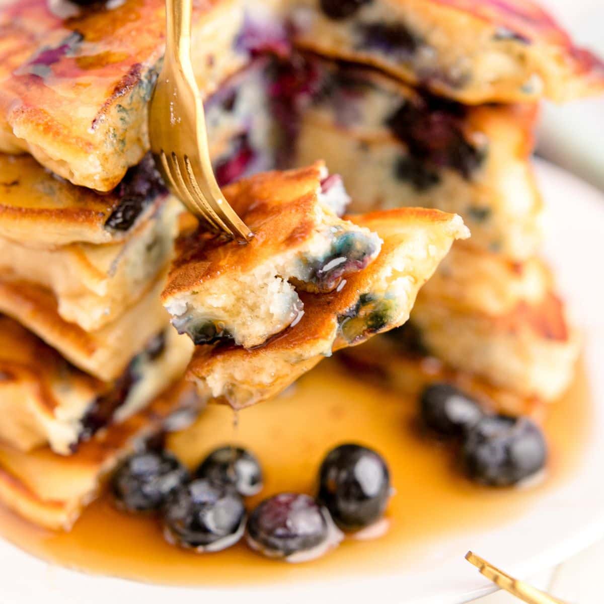 blueberry pancakes with syrup on a fork