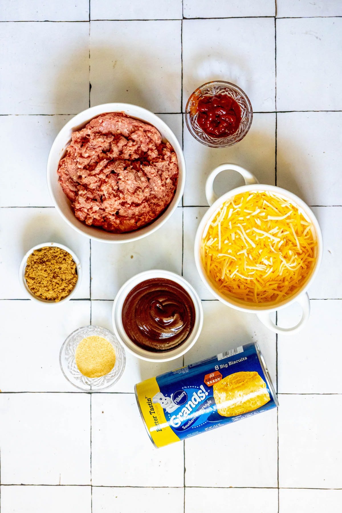 ground beef, cheese, bbq sauce, herbs, biscuits on a table