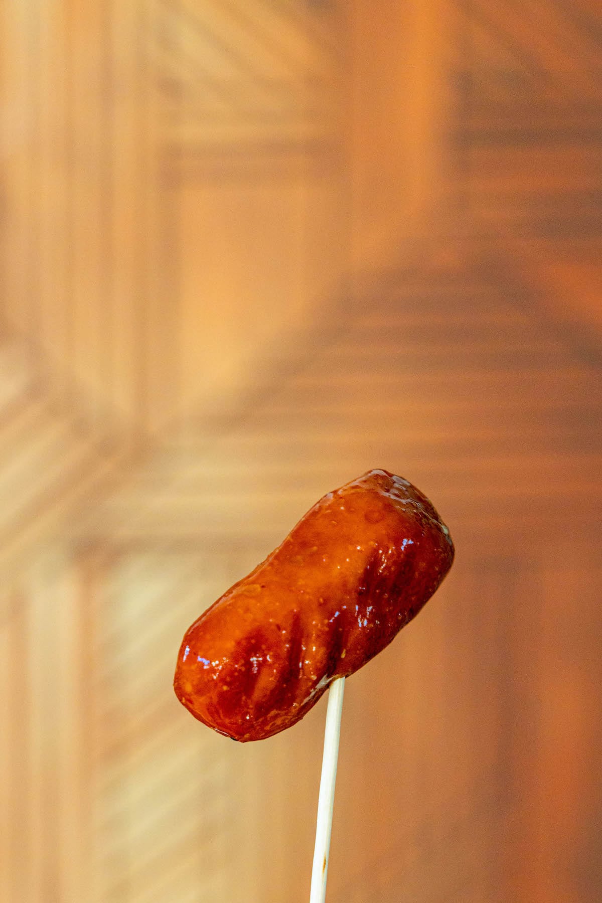 little smokie sausage in bbq sauce on a toothpick 