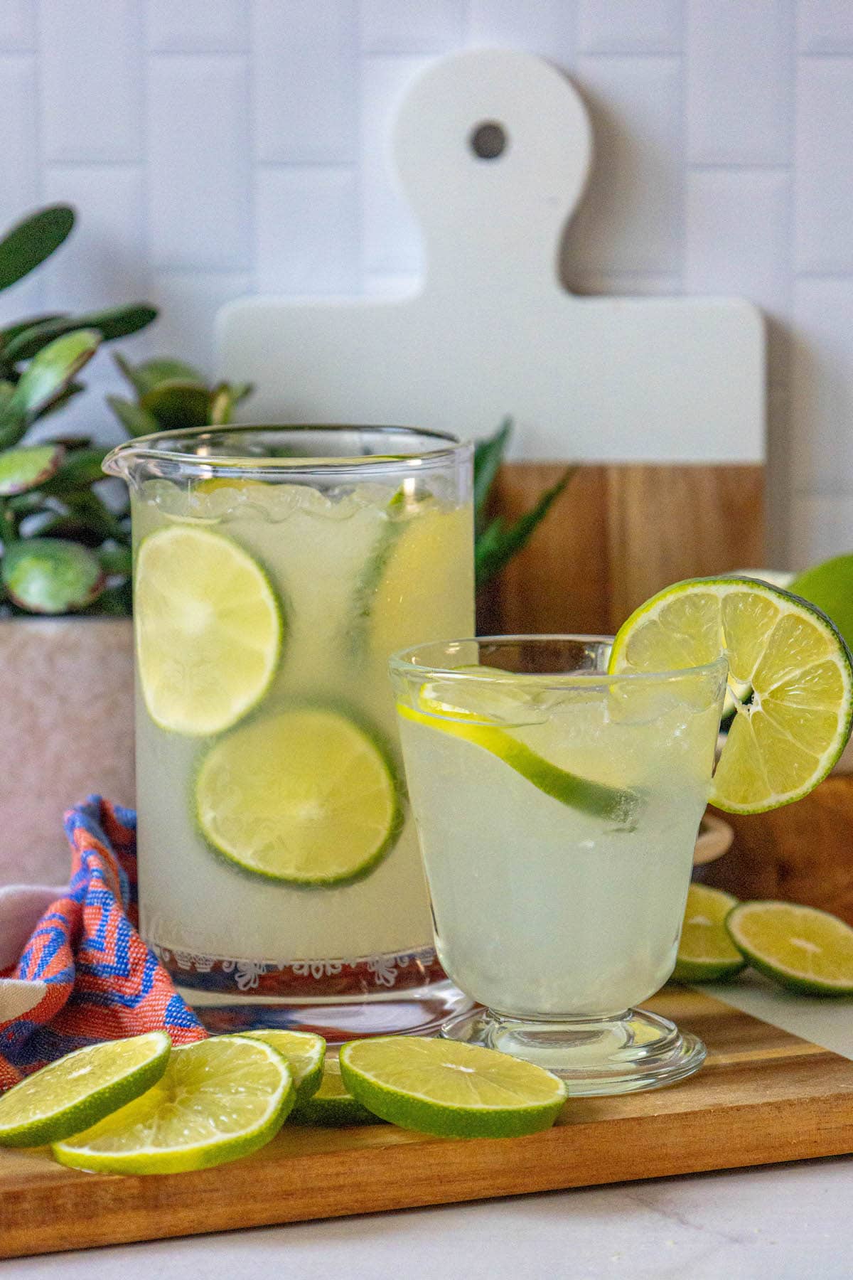 limeade in a glass with ice and sliced limes
