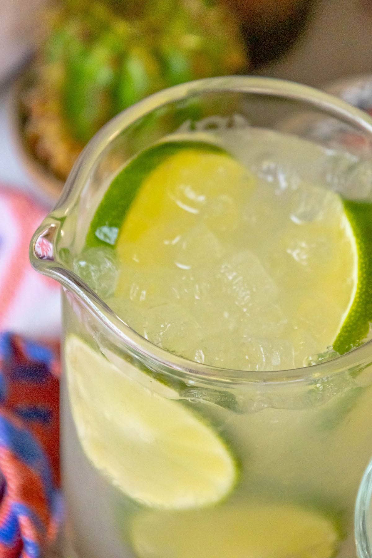 limeade in a pitcher with ice and sliced limes