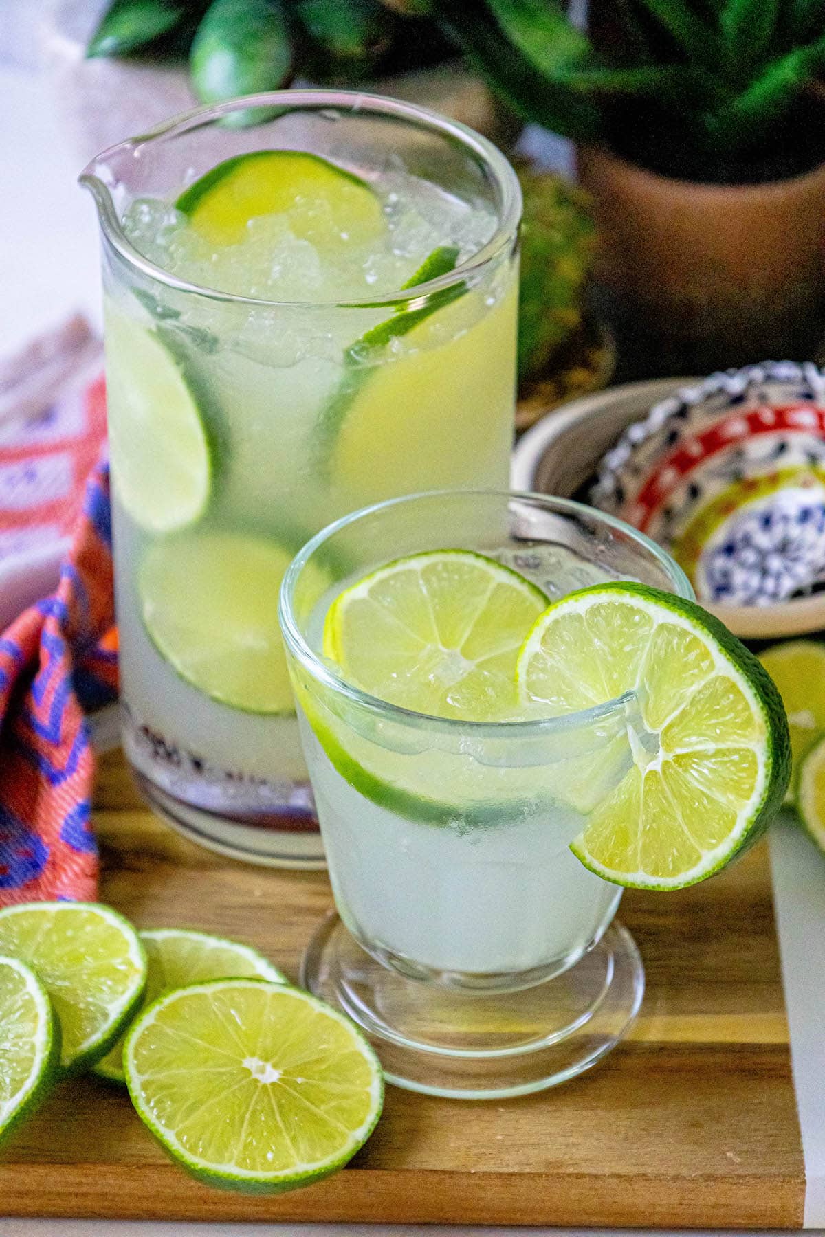 limeade in a glass with ice and sliced limes