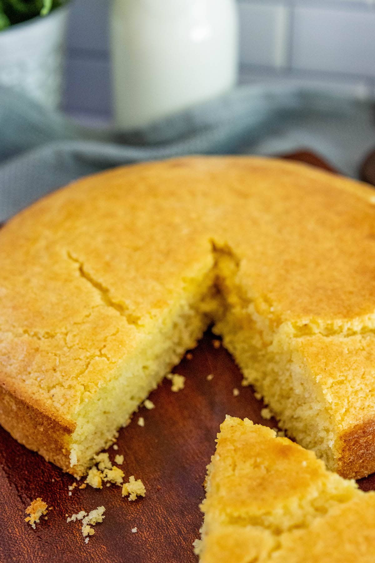 a loaf of cornbread with a slice cut out of it