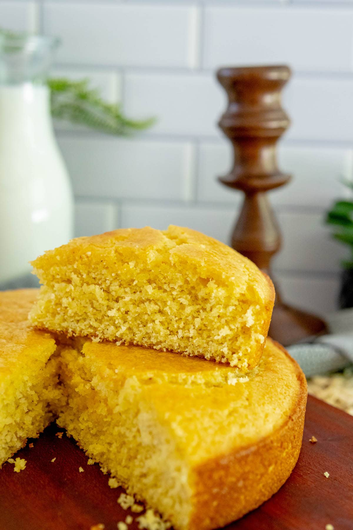 a slice of honey butter cornbread sliced and placed on top of other slices of cornbread on a table