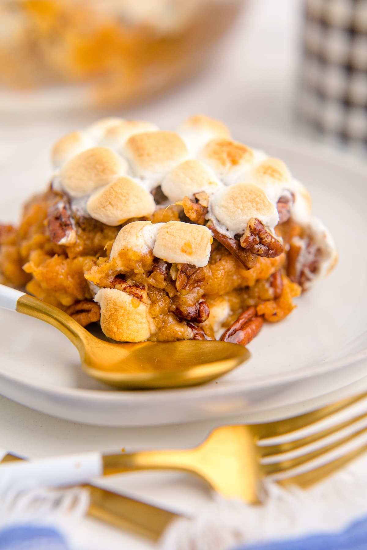 sweet potato with pecans and marshmallows on a plate