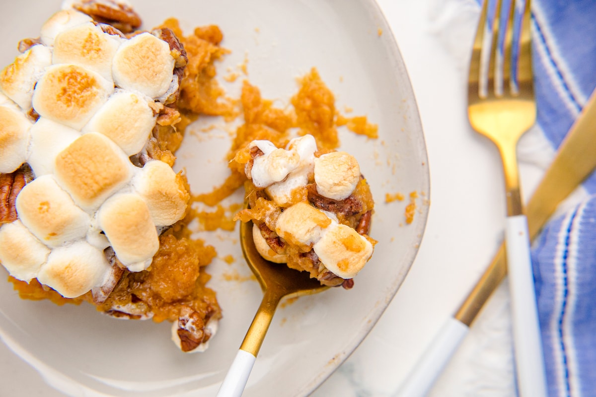 sweet potato with pecans and marshmallows on a spoon
