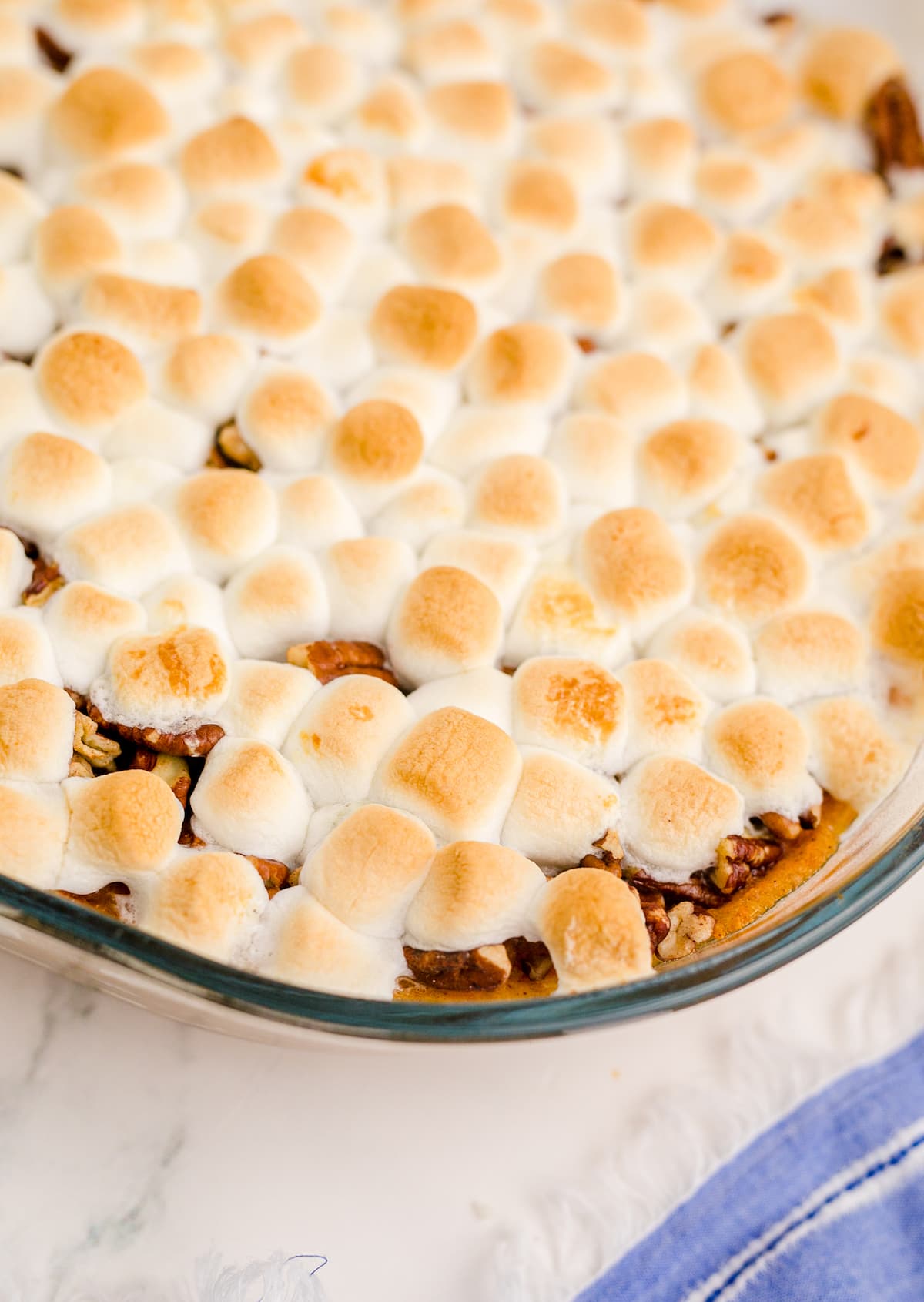casserole dish with pecans and mashmallows on it