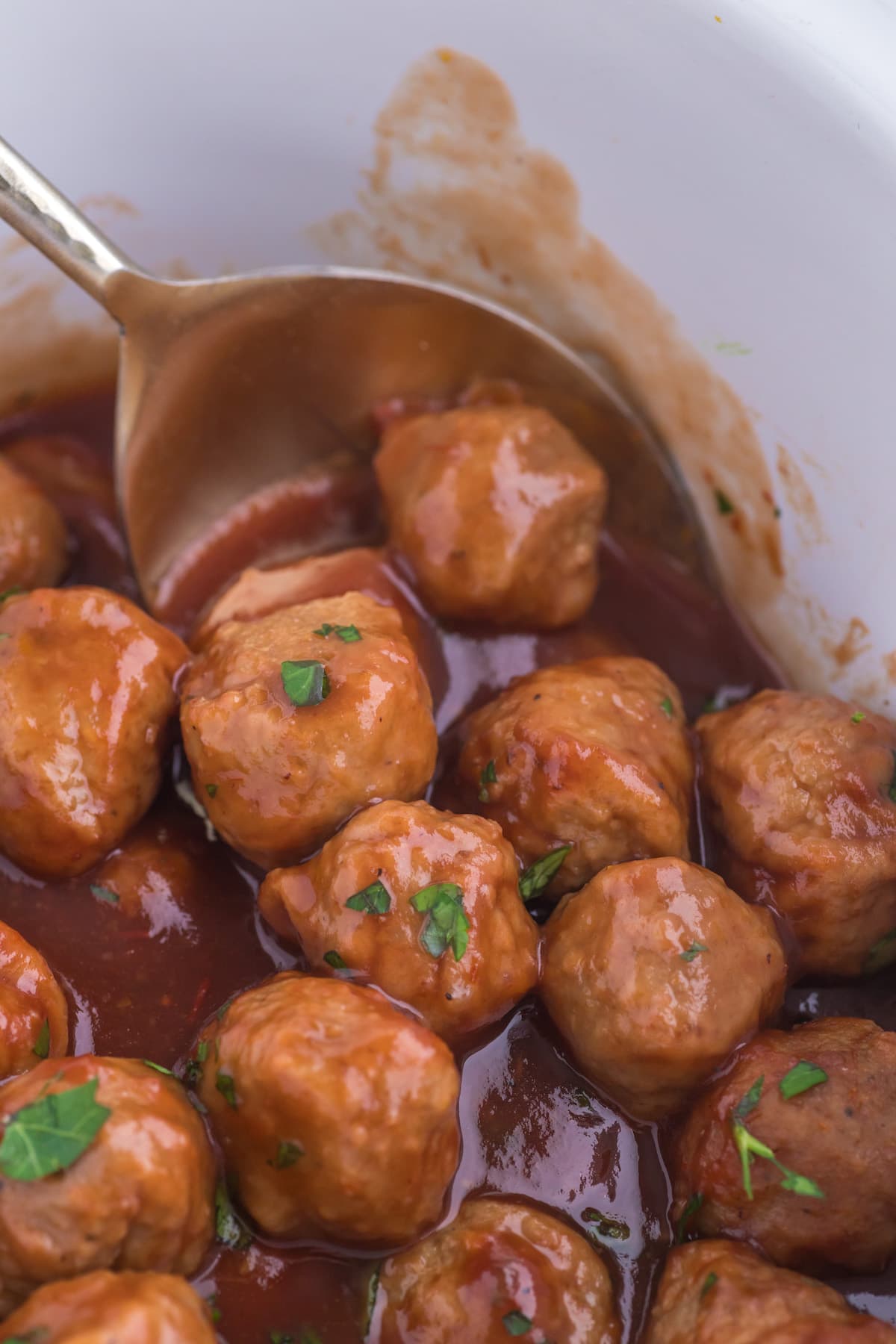 meatballs in a slow cooker in cranberry sauce