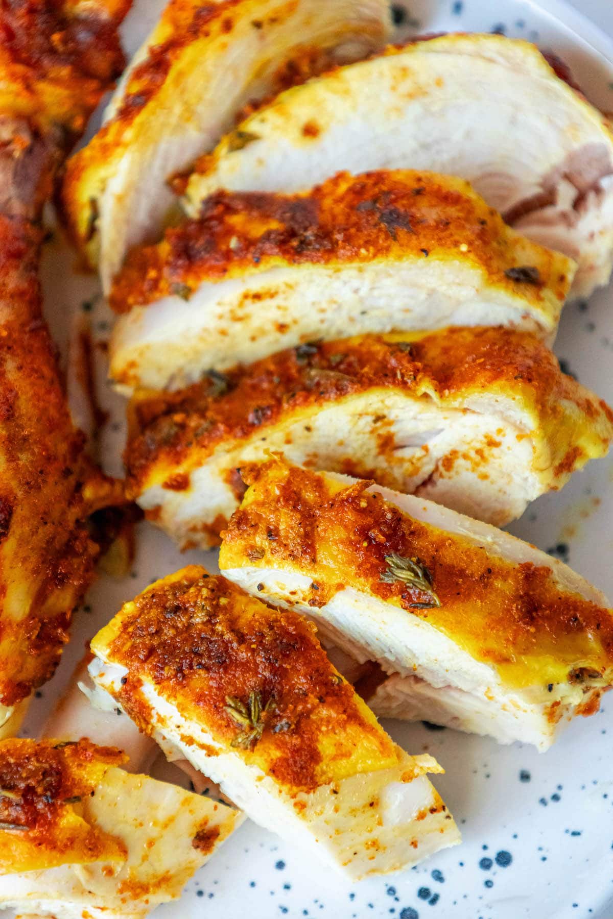 roasted chicken with garlic turmeric rub sliced on a dish