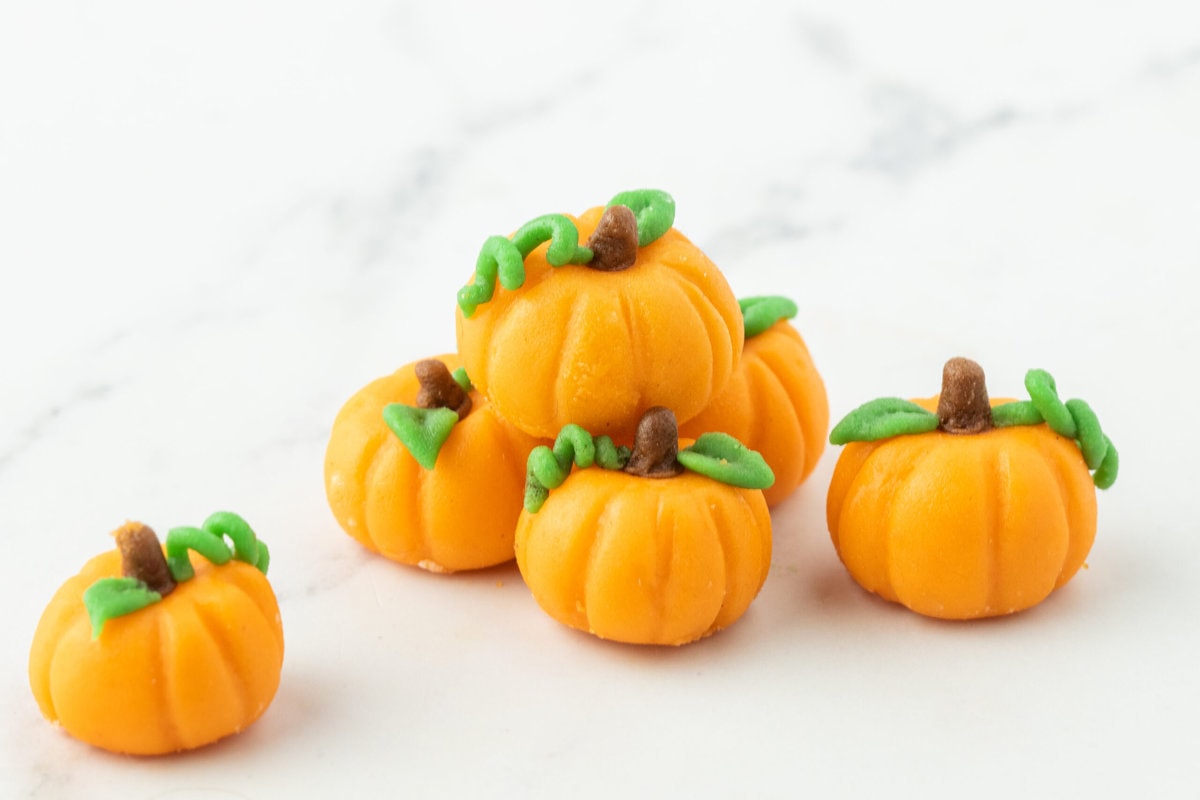 marzipan pumpkins with stem and leaf on a table