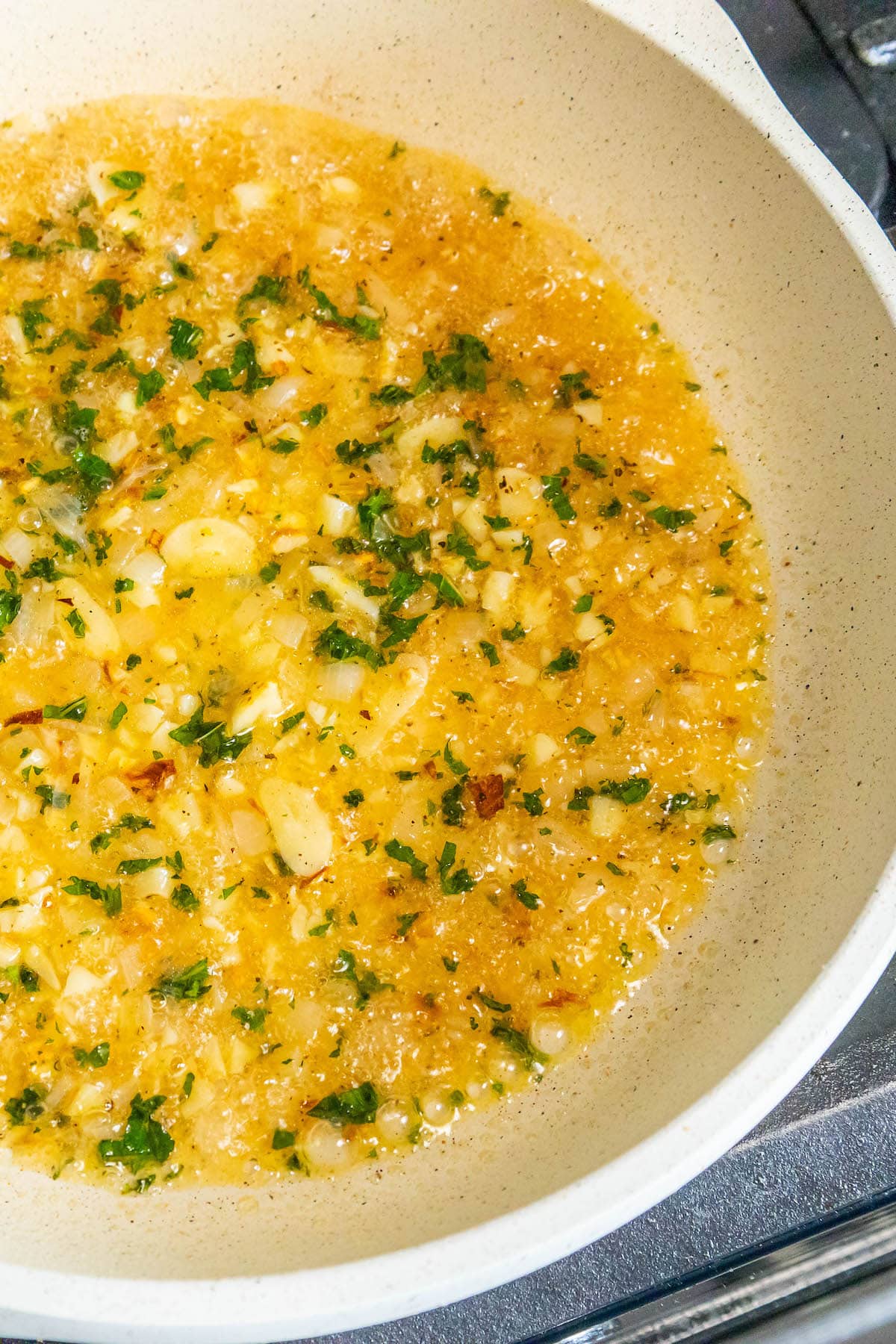 sauteed garlic, shallot, and mint in a pan with white wine