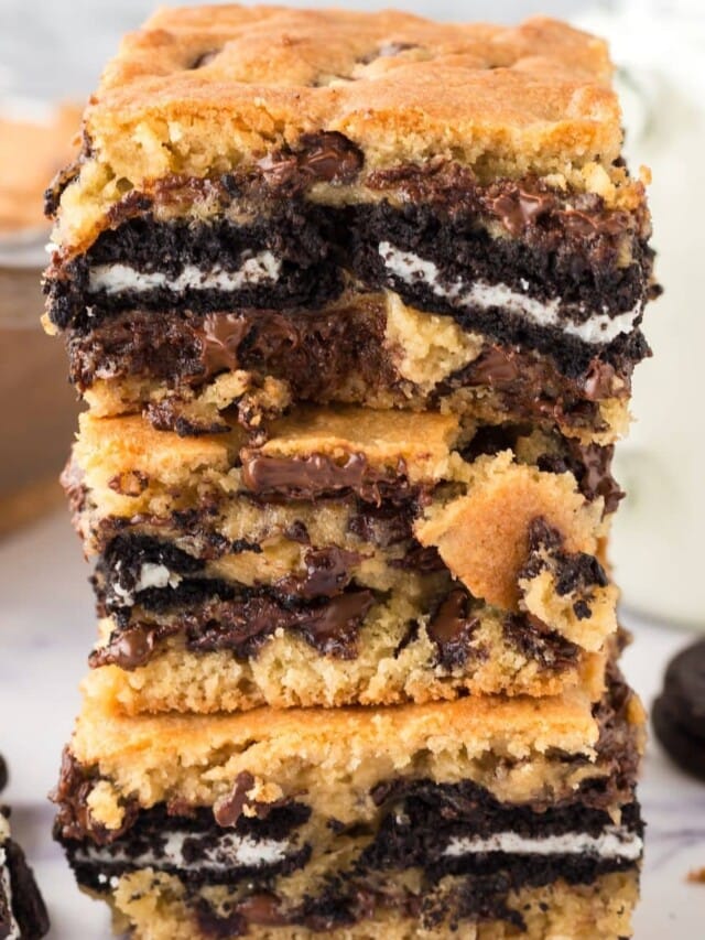 cookie bars baked with oreos stuffed in the middle stacked on top of each other on a table