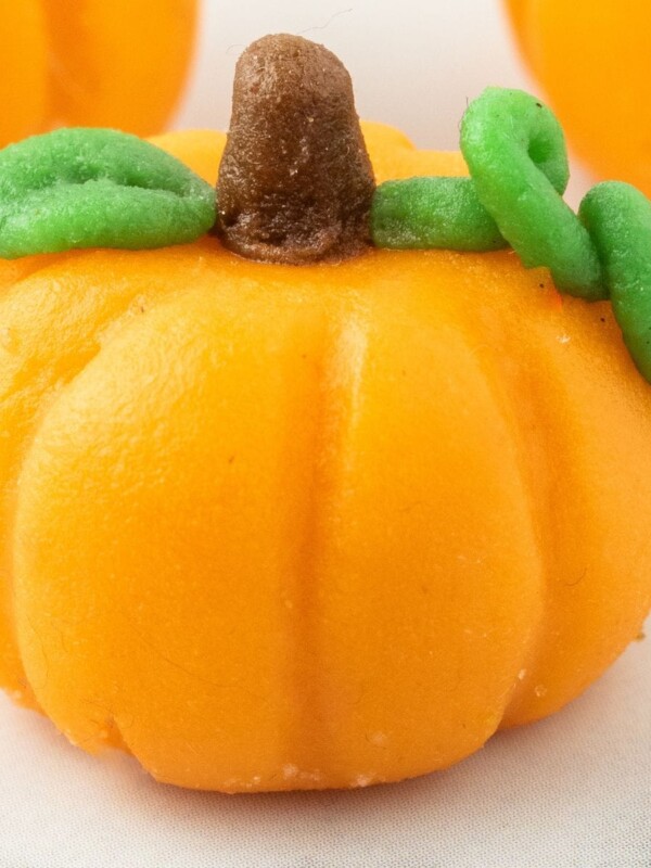 marzipan pumpkin with stem and leaf on a table
