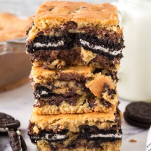 cookie bars baked with oreos stuffed in the middle stacked on top of each other on a table