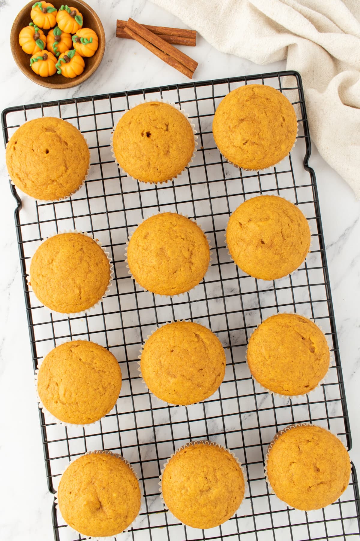 baked pumpkin cupcakes on a cooling tray
