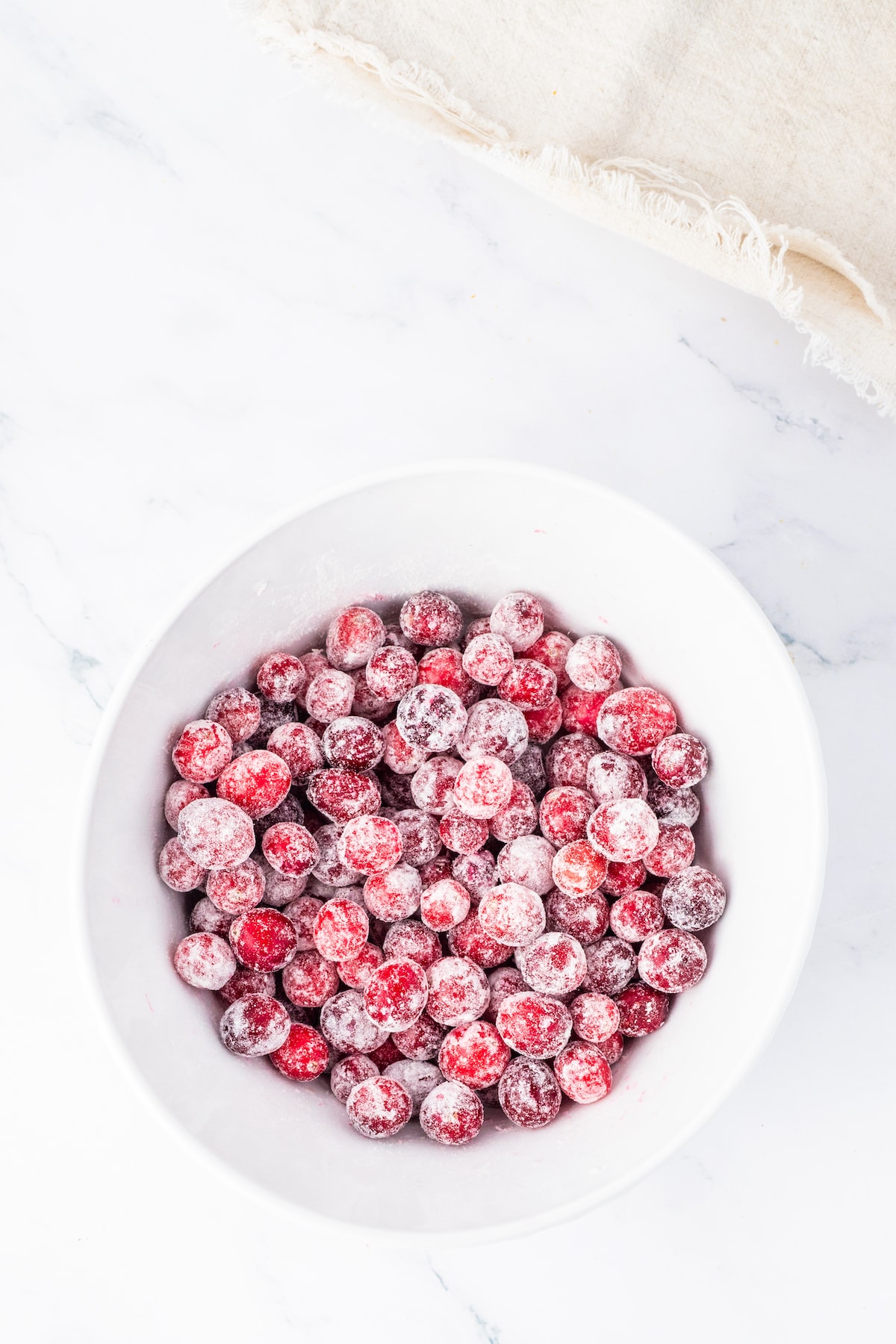 cranberries covered in sugar in a bowl