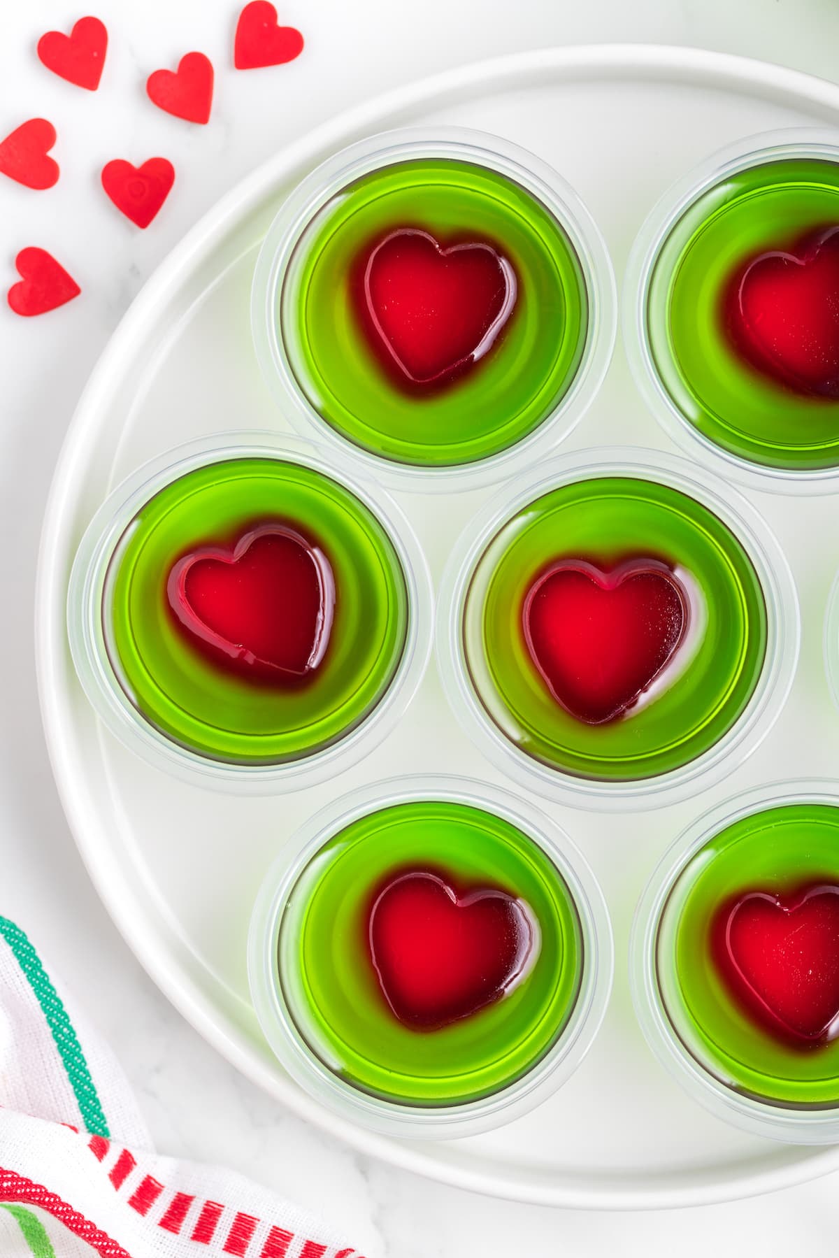 green jello in containers with a red heart in the center