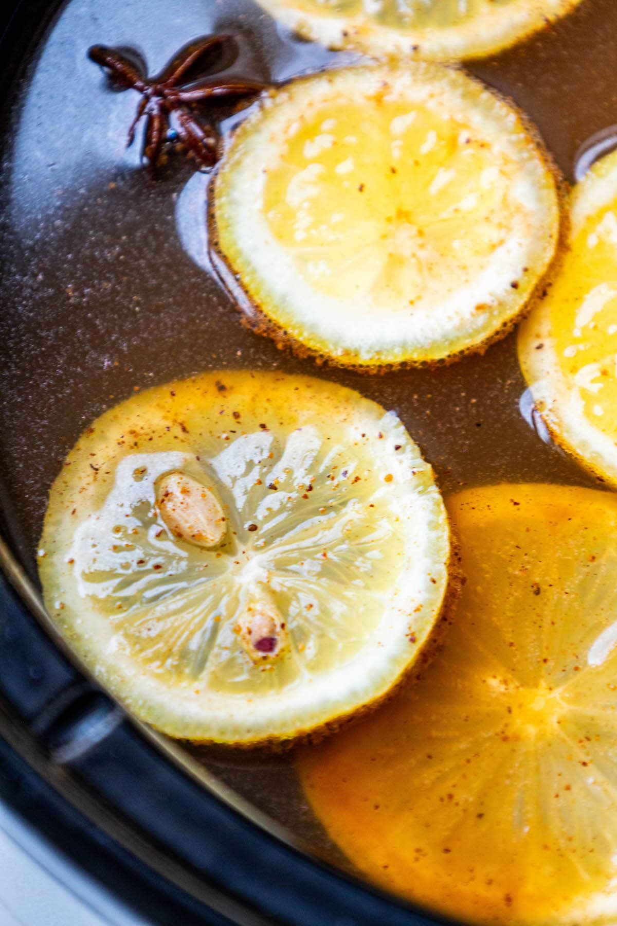 cider with cinnamon sticks, star of anise, and cardamom pods