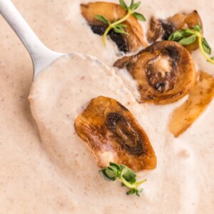 mushroom soup on a spoon with roasted mushrooms on top