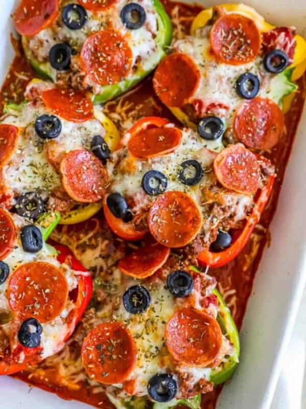 Pepperoni stuffed peppers in a baking dish.