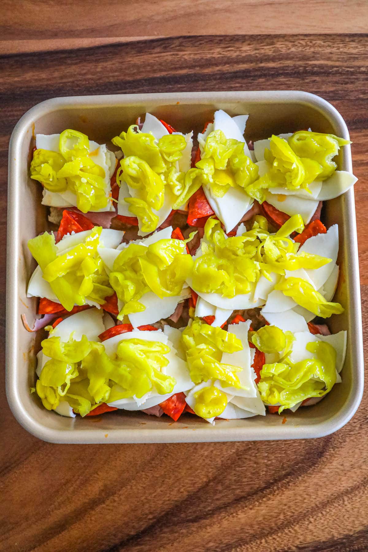 rolls with ham, cheese, and pepperoncini on them