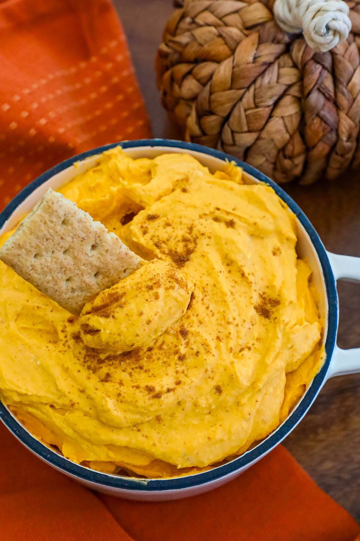 cool whip pumpkin pie fluff in a white bowl with graham crackers in it