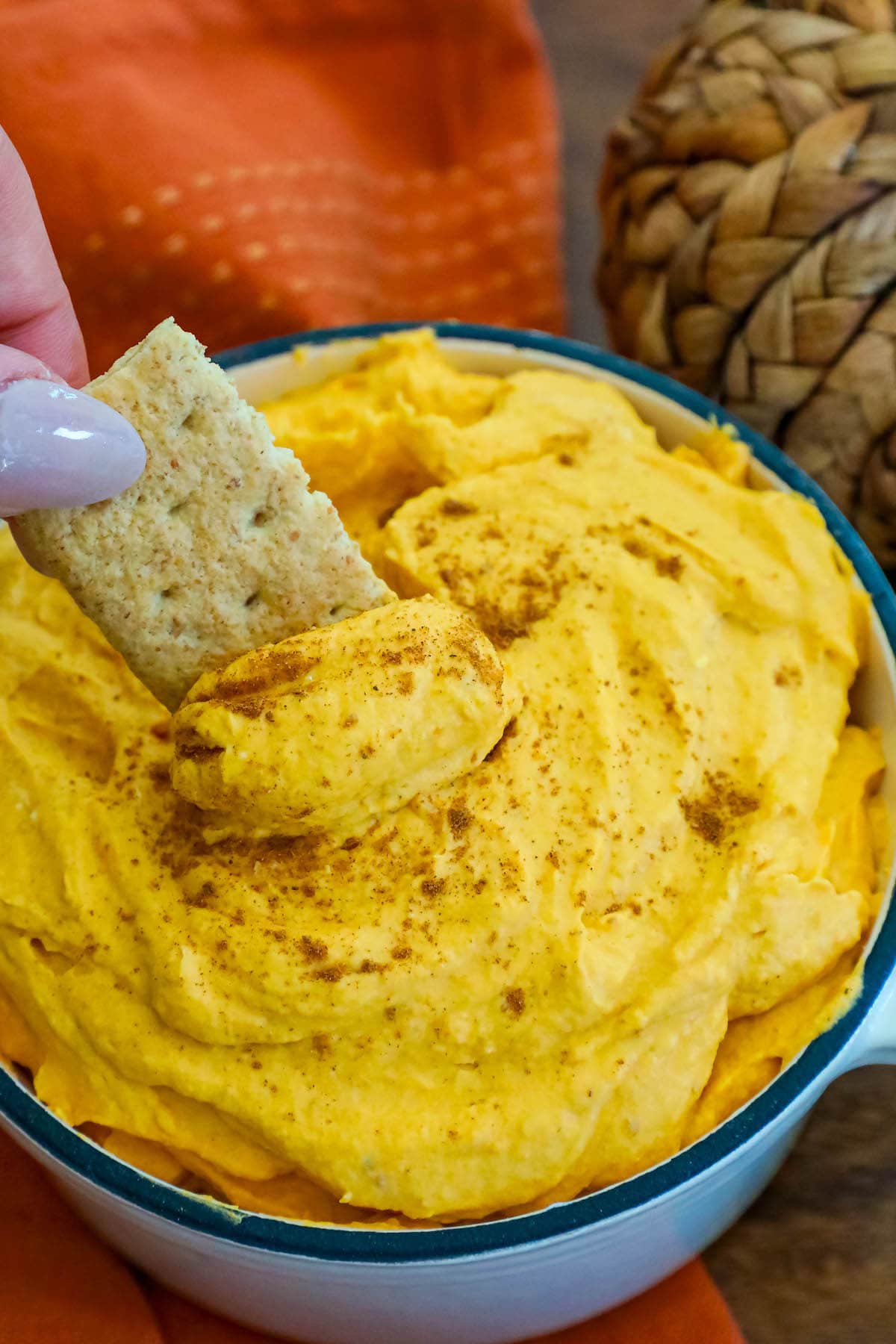 cool whip pumpkin pie fluff in a white bowl with graham crackers in it