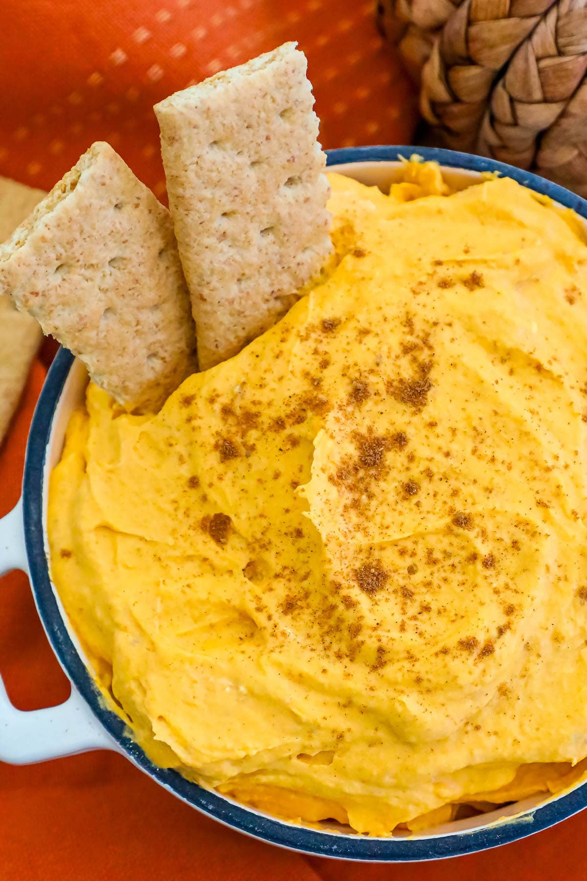 cool whip pumpkin pie fluff in a white bowl with graham crackers in it