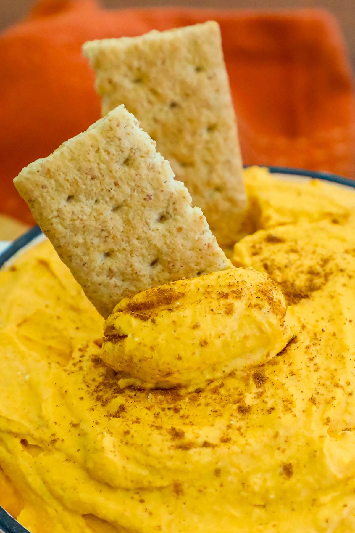 cool whip pumpkin pie fluff in a white bowl with graham crackers in it