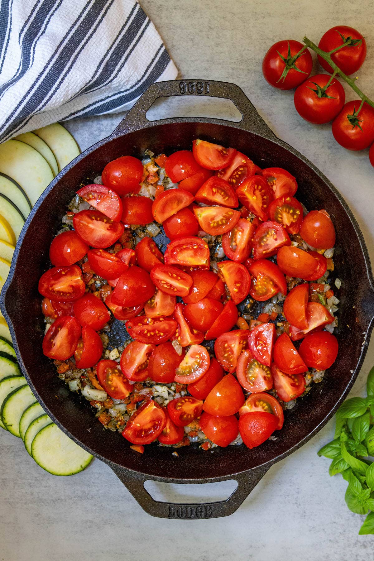 herbs, onions, and tomatoes in a pan