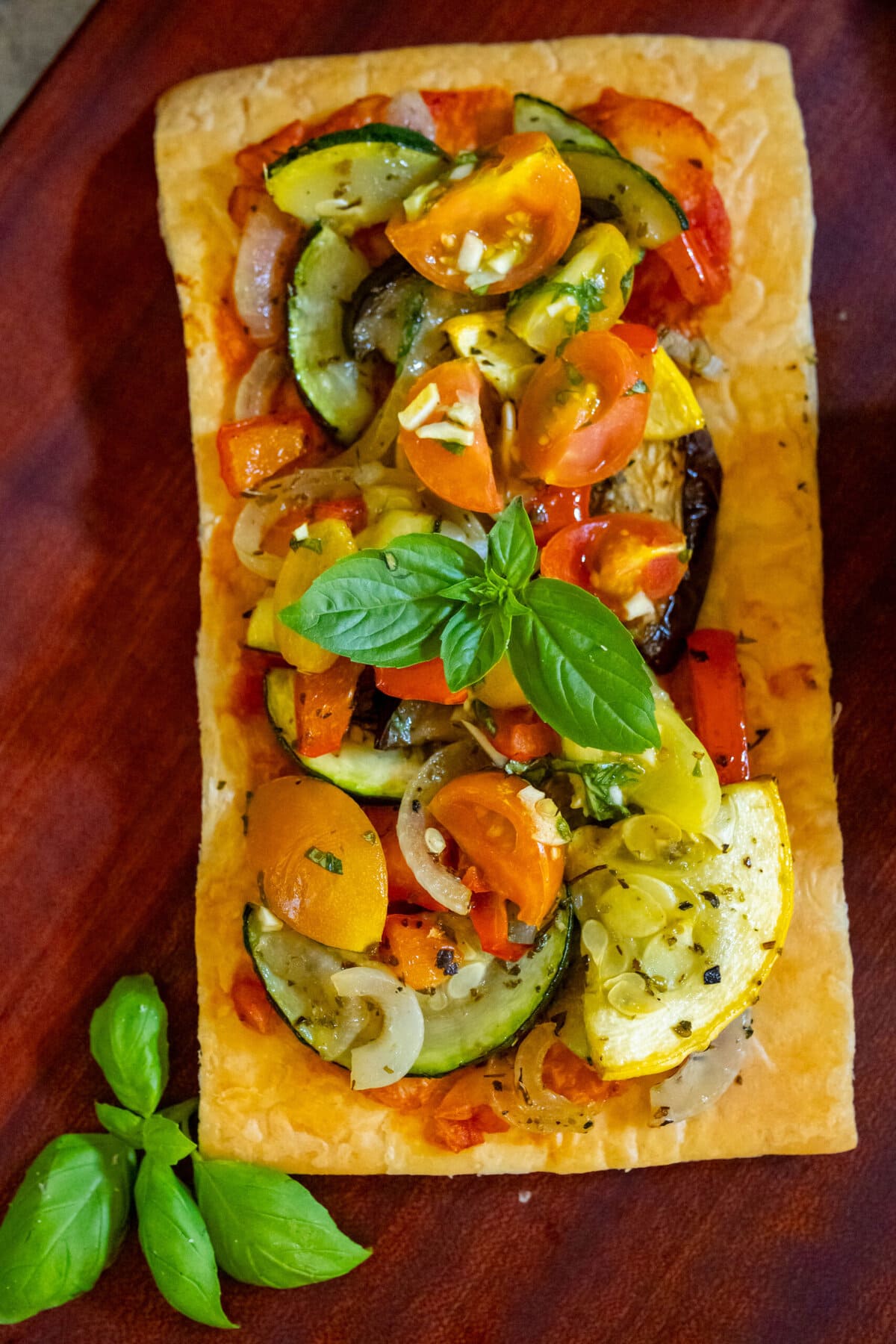 baked tarts with ratatouille on top on a table